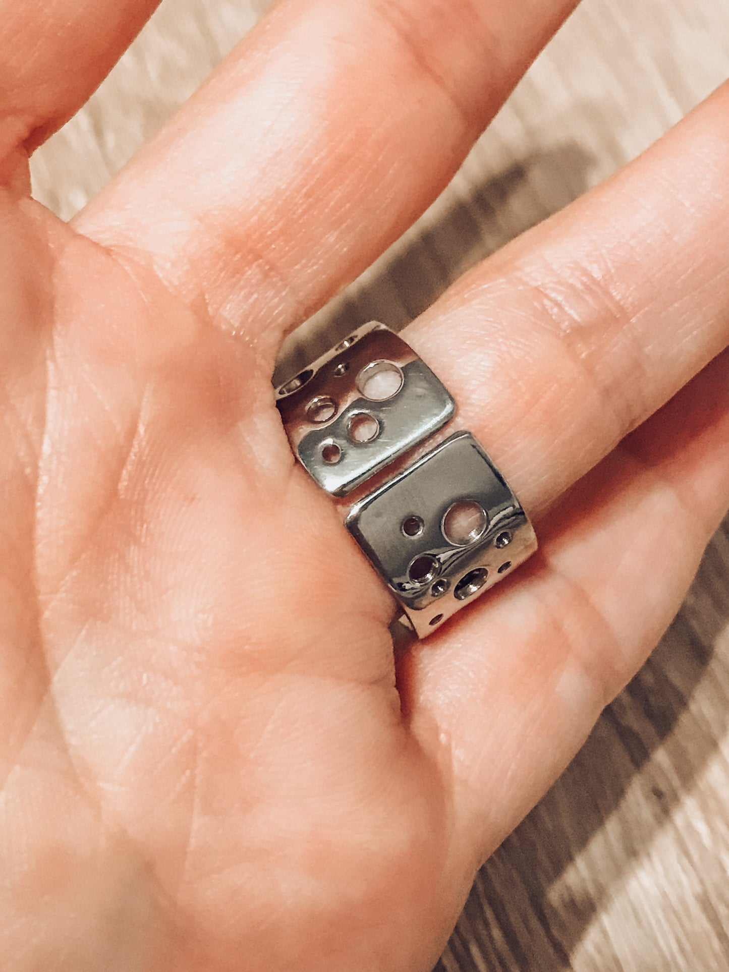 Pure titanium boho-style statement ring with varying hole sizes and a slightly adjustable design. Lightweight, durable, hypoallergenic, and tarnish-resistant