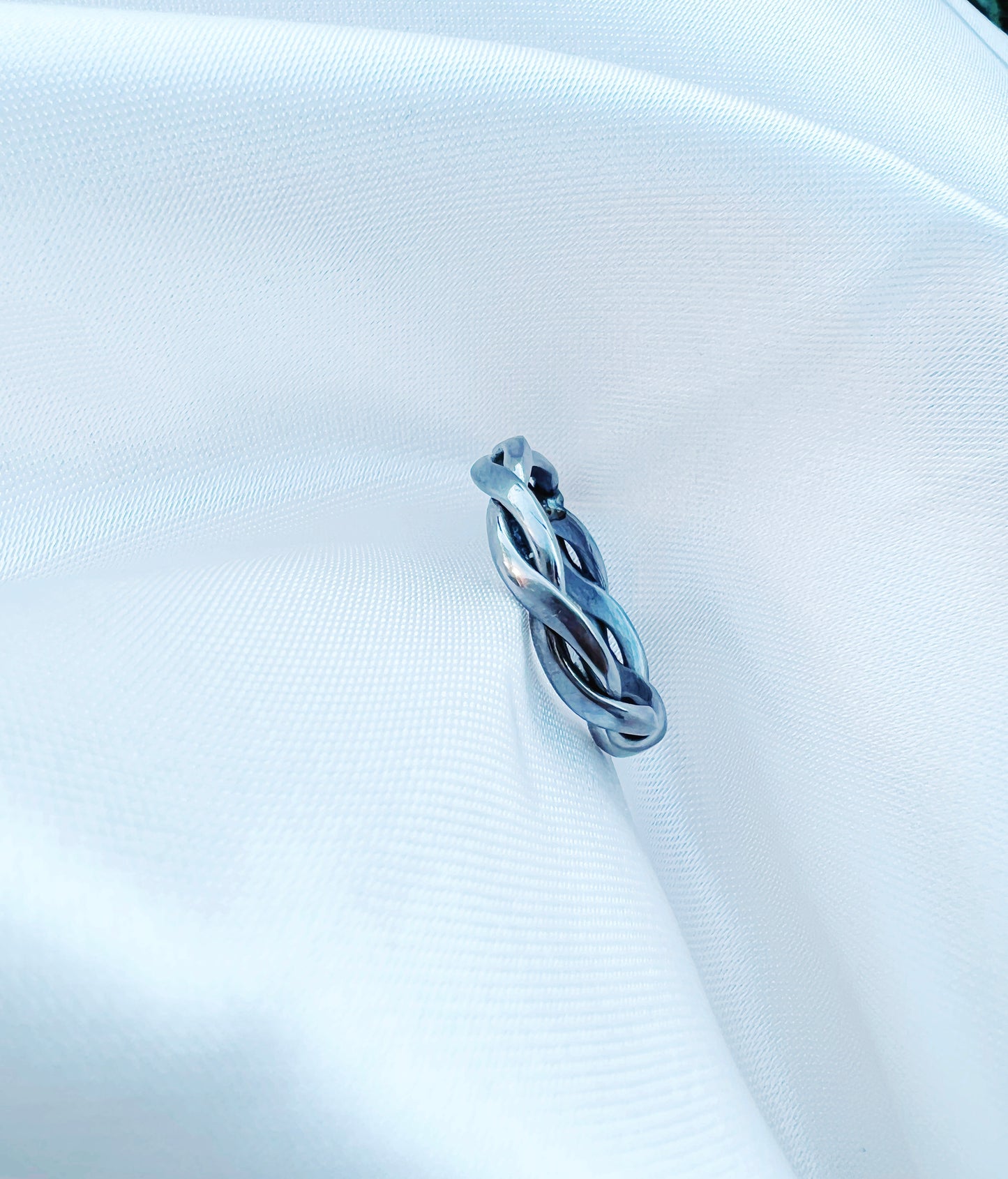 Pure titanium braided ring with intricate woven design. Lightweight, durable, hypoallergenic, and tarnish-resistant, suitable for sensitive skin