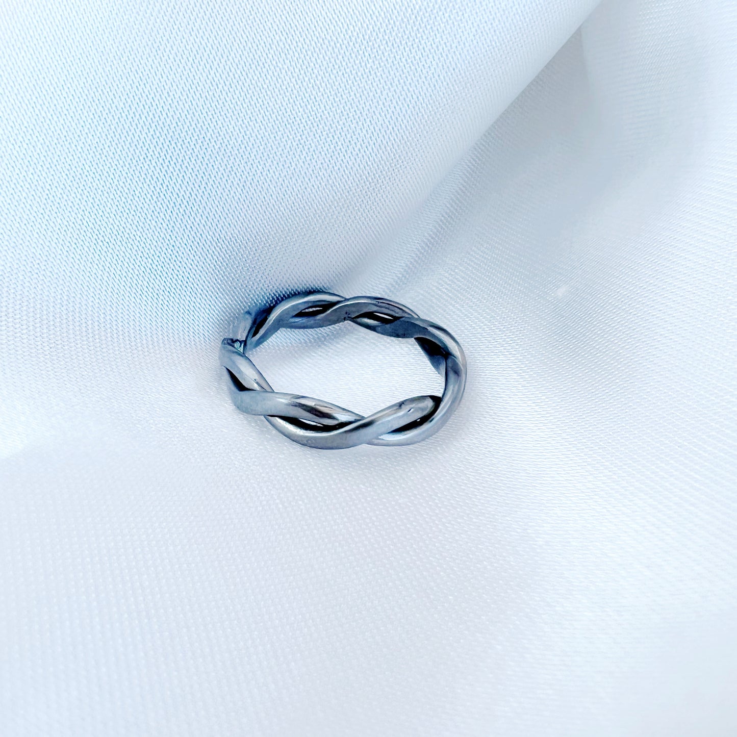 Pure titanium braided ring with intricate woven design. Lightweight, durable, hypoallergenic, and tarnish-resistant, suitable for sensitive skin