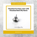 Light blue Titanium Children's Earrings featuring Elsa and Anna from Frozen, available in 8mm or 10mm sizes. Hypoallergenic and adorned with enchanting characters for a touch of magical style in every wear."
