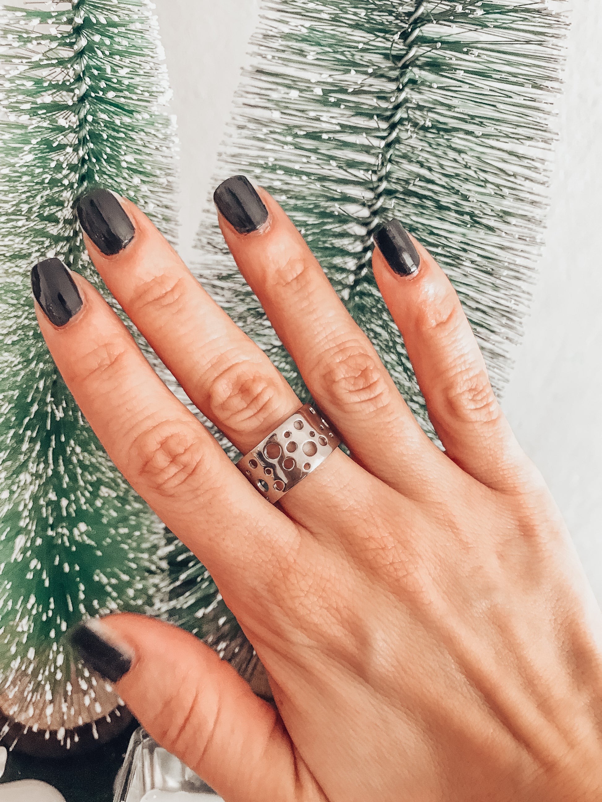Pure titanium boho-style statement ring with varying hole sizes and a slightly adjustable design. Lightweight, durable, hypoallergenic, and tarnish-resistant