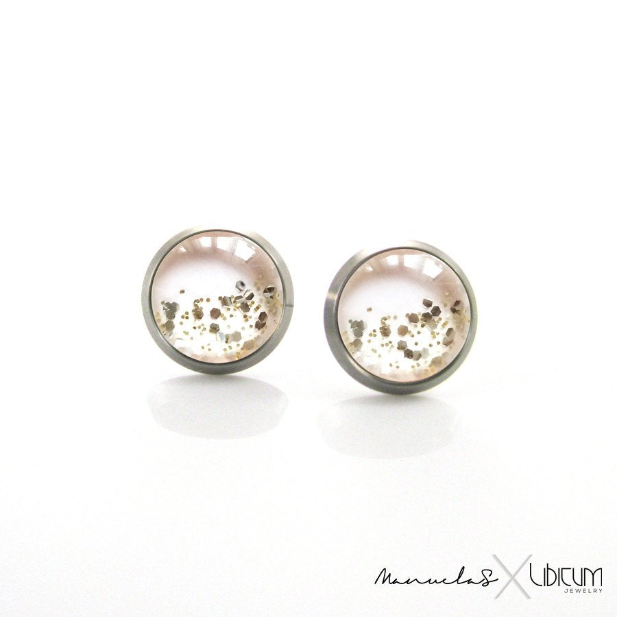 Very light pink titanium earrings with subtle shimmer, available in 8mm and 10mm sizes. Lightweight, hypoallergenic, and perfect for sensitive ears.